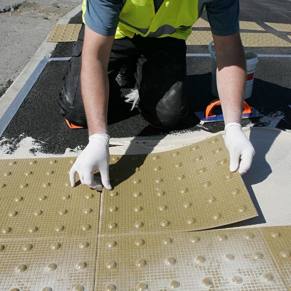 stick on Tactile Paving slabs being applied outside 