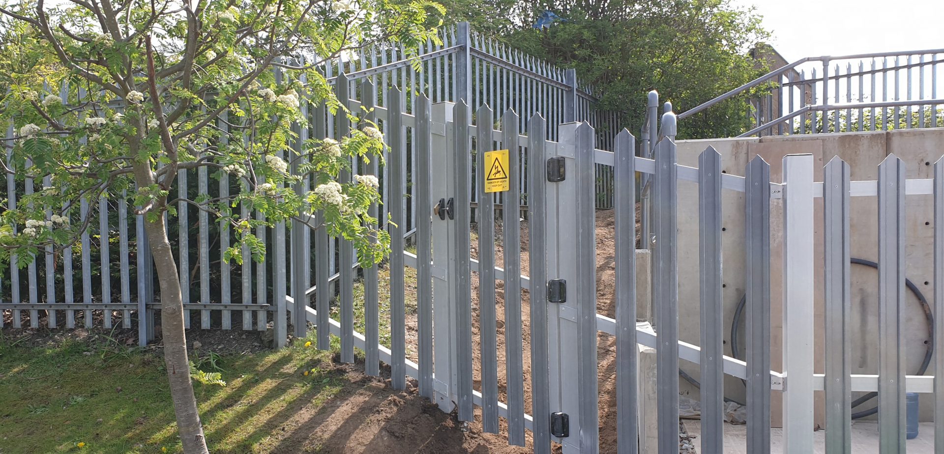 GRP palisade security fence and gate alongside steel fence electrical installation