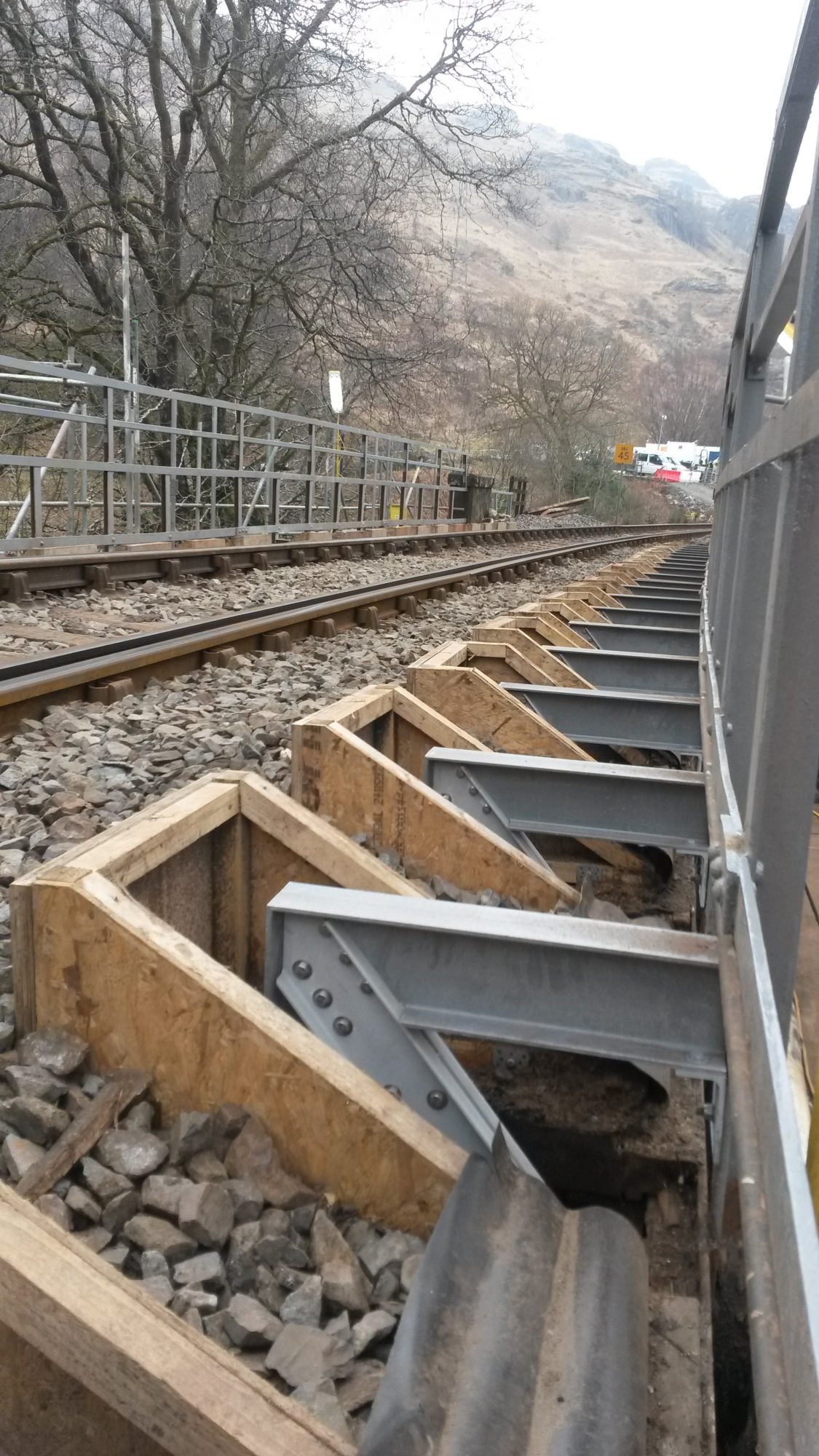 Railway bridge cantilevered GRP trackside walkway under construction